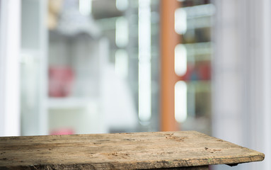 Empty of wood table top on blur of curtain with window view green from tree garden background.For montage product display or design key visual layout
