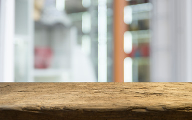 Empty of wood table top on blur of curtain with window view green from tree garden background.For montage product display or design key visual layout