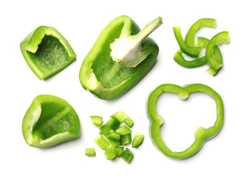 Cut green bell peppers on white background, top view