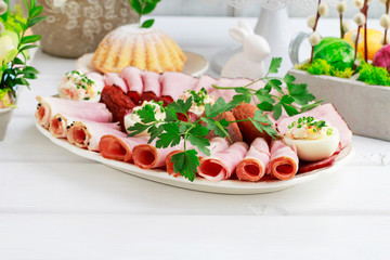 Plate with sliced ham and stuffed eggs.
