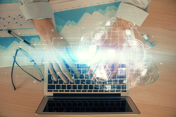 Social network theme hologram with businessman working on computer on background. Concept of world...
