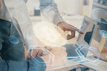 Crypto currency theme hologram with businessman working on computer on background. Concept of...