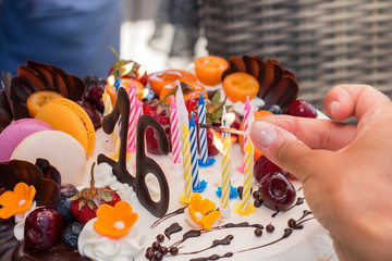 festive cake with fruit light candles