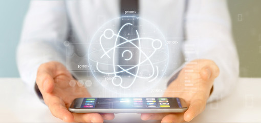 Businessman holding an atom icon surrounded by data