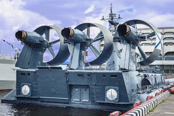 view of a modern warship with a powerful gas turbine engine parked at the port
