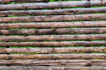 Large and high fence assembled from boards.