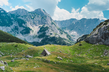 Fototapeta na wymiar Rocks and wooden old hut in mountaines valley in Durmitor National Park