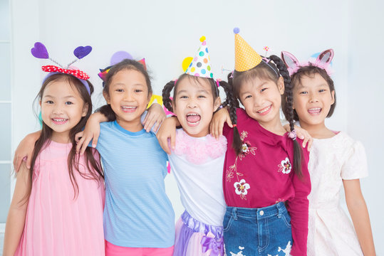 Group of adorable asian girls having fun at birthday party..