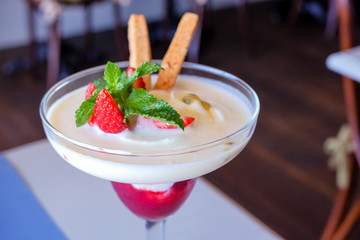 Summer dessert, classic cheesecake with strawberries decorated with mint leaves.berry dessert with mint.Healthy and tasty yogurt detox smoothie with pieces of ripe strawberries in a glass.Copy space