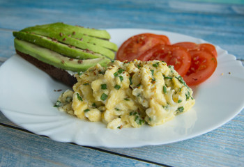 Sandwich with avocado and cheese, scramble and tomatoes