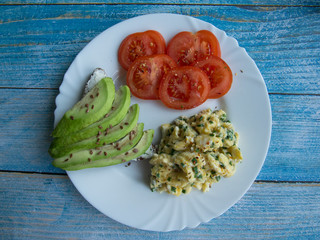 Sandwich with avocado and cheese, scramble and tomatoes