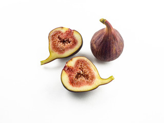 The purple fruits of ripe figs are whole and sliced. Isolated