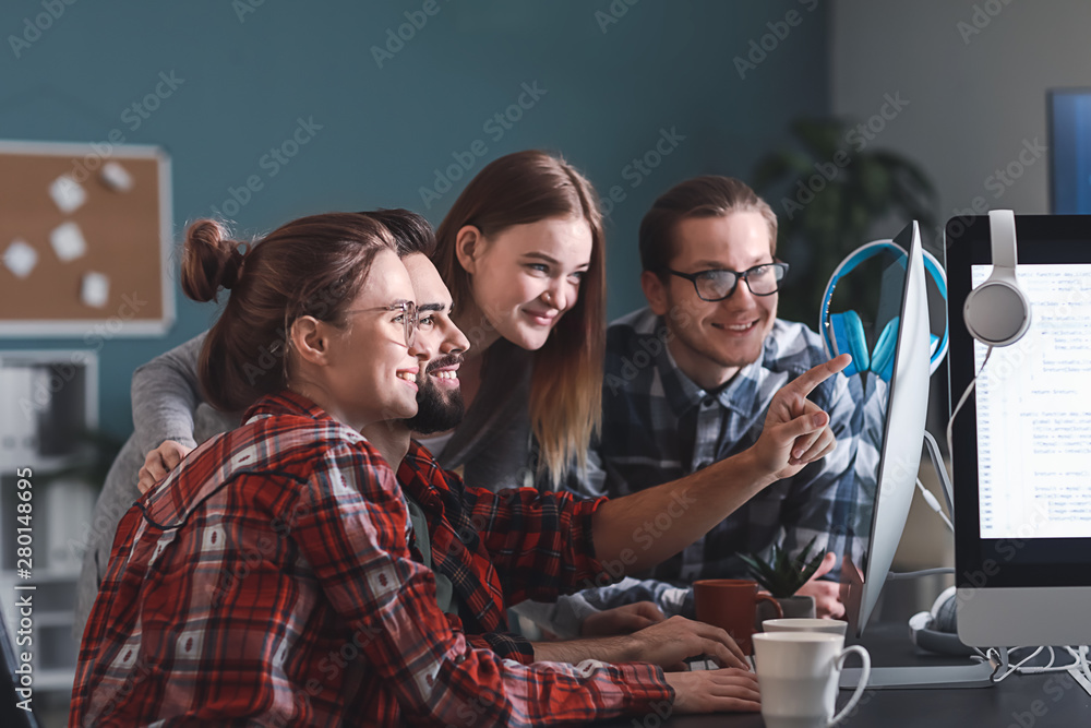 Poster team of programmers working in office
