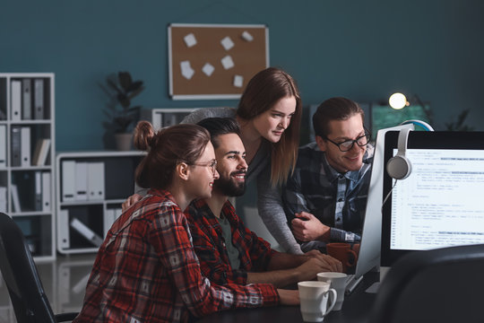 Team of programmers working in office