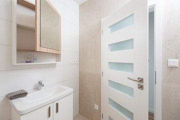 Contemporary bathroom interior with mirror and cabinet