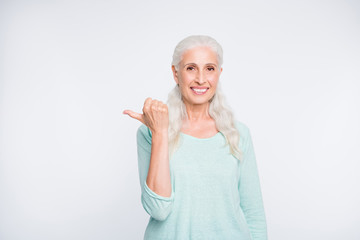 Portrait of confident person showing advertisement with her thumb wearing turquoise jumper isolated over white background