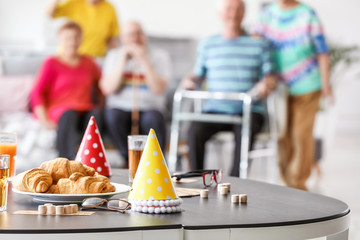 Table with party decor and bingo game on table in nursing home