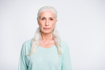 Portrait of concentrated charming woman looking wearing teal pullover isolated over white background
