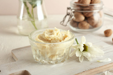 Bowl with shea butter on table