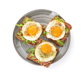 Plate with tasty toasts on white background
