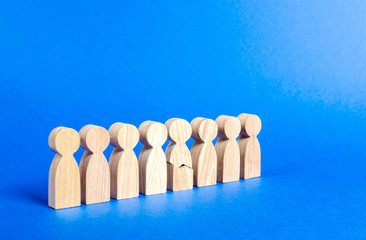 Cracked human figure in line of people. The concept of a weak link. High workload and stress at...