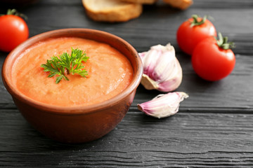 Bowl of tasty cream soup on table