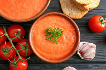 Bowls of tasty cream soup on table