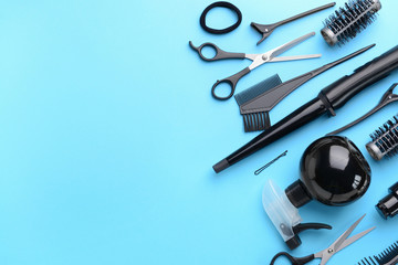 Set of hairdresser tools and accessories on color background