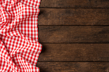 Red checkered tablecloth on wooden background - Powered by Adobe