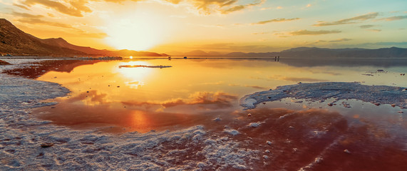 beautiful landscape and sunset with sky reflection over salty Lake Maharlu in Iran, Fars Province...