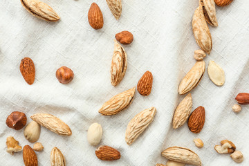 Many almonds on white cloth