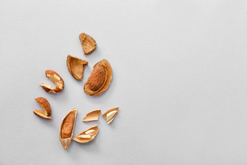 Cracked almonds on light background