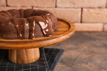 Dessert stand with tasty chocolate cake on table