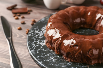 Plate with tasty chocolate cake on table
