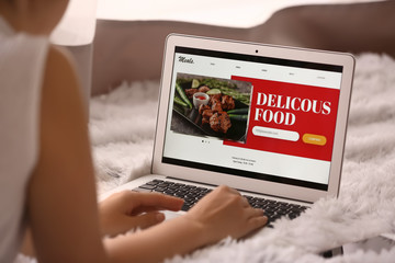 Woman with laptop ordering food online