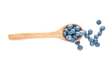 Spoon with ripe blueberry on white background