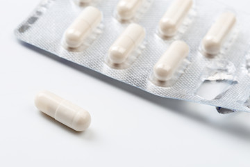 Pile of white capsules probiotic powder inside. Copy space. High resolution product. Health care concept - Image