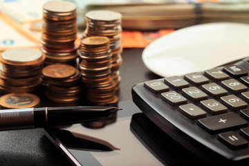 Financial business concept combination with coins, money, calculator and pen