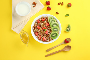 Bowl with tasty sweet oatmeal on color background