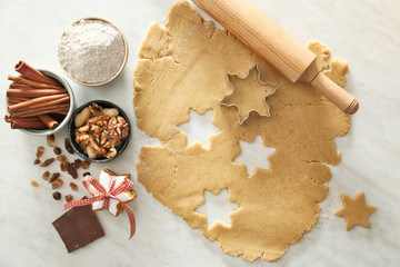 Preparing of tasty Christmas cookies on light background