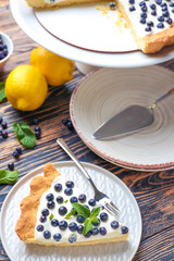 Composition with tasty bilberry pie on table