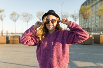 Outdoor portrait of smiling teen girl 13, 14 years old