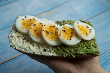Sandwich with avocado paste, cottage cheese and sliced boiled egg
