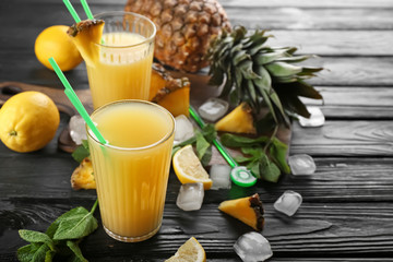 Composition with fresh pineapple juice on wooden table