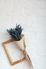 Obraz premium dry lavender flowers in the interior, against a white brick wall