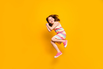 Fototapeta na wymiar Full size photo of nice sweet girl jumping isolated over yellow background