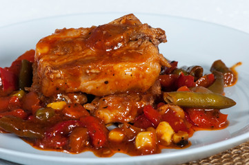 Pork ribs with corn, pepper, tomatoes and green beans.