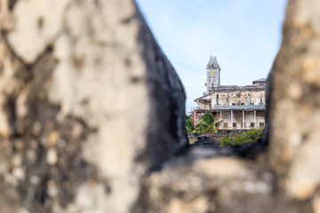 view of the palace of wonders building stone town zanzibar through the buttress of he nearby castle