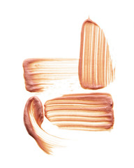 Gently beige strokes and texture of face highlighter or acrylic paint isolated on white background