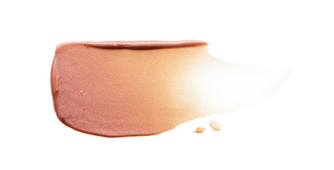 Gently beige strokes and texture of face highlighter or acrylic paint isolated on white background